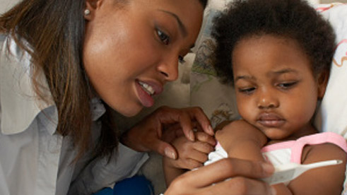 — title missing — Mother checks daughter's temperature.