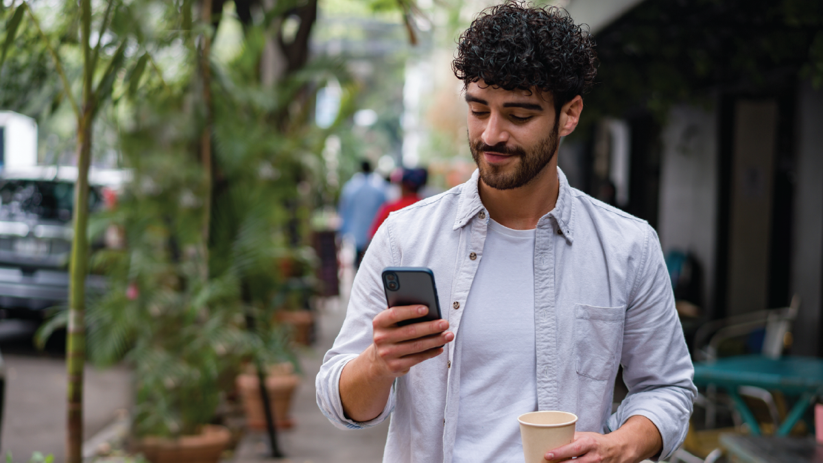 HIV Social Media Thumbnail Image of man holding and looking at a smartphone.