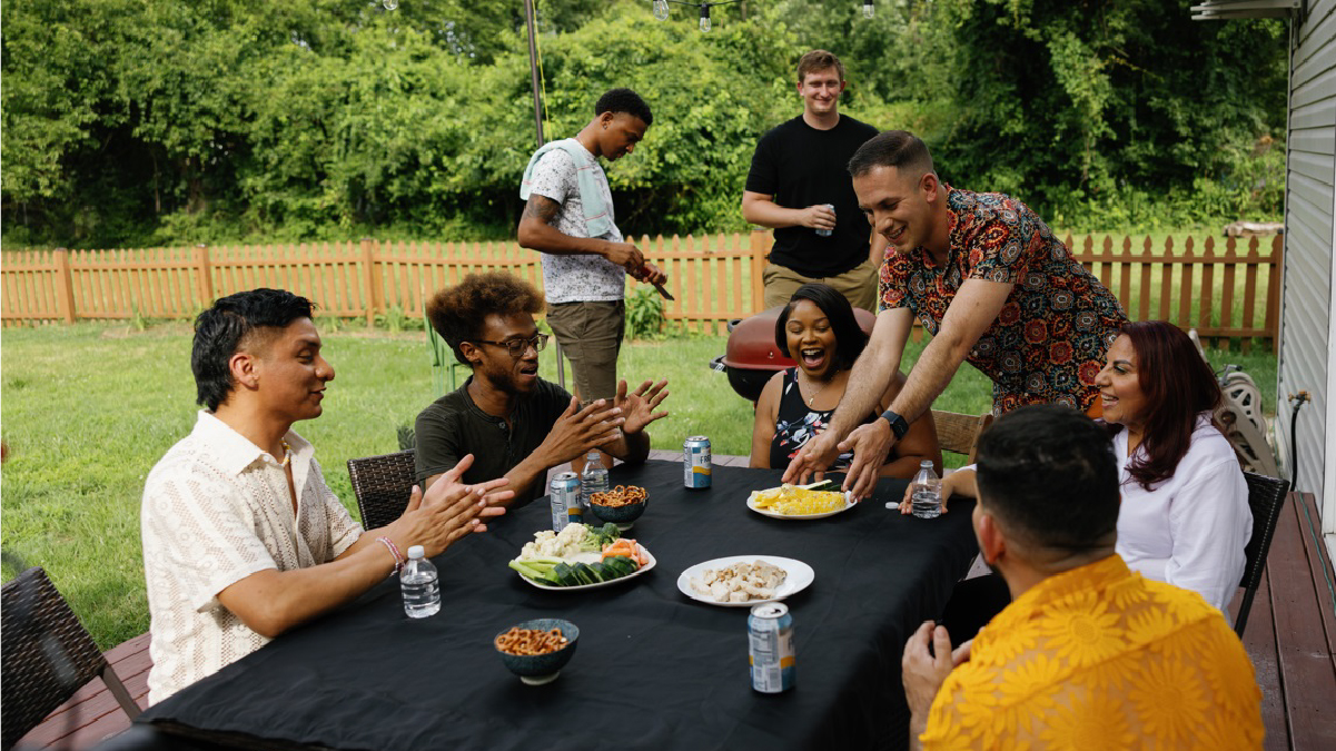 Race People at a table socializing.