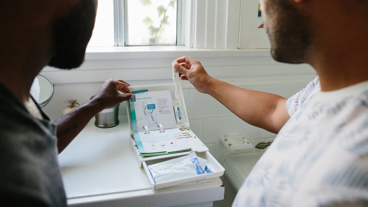 Testing Two people looking at an HIV self-test kit.