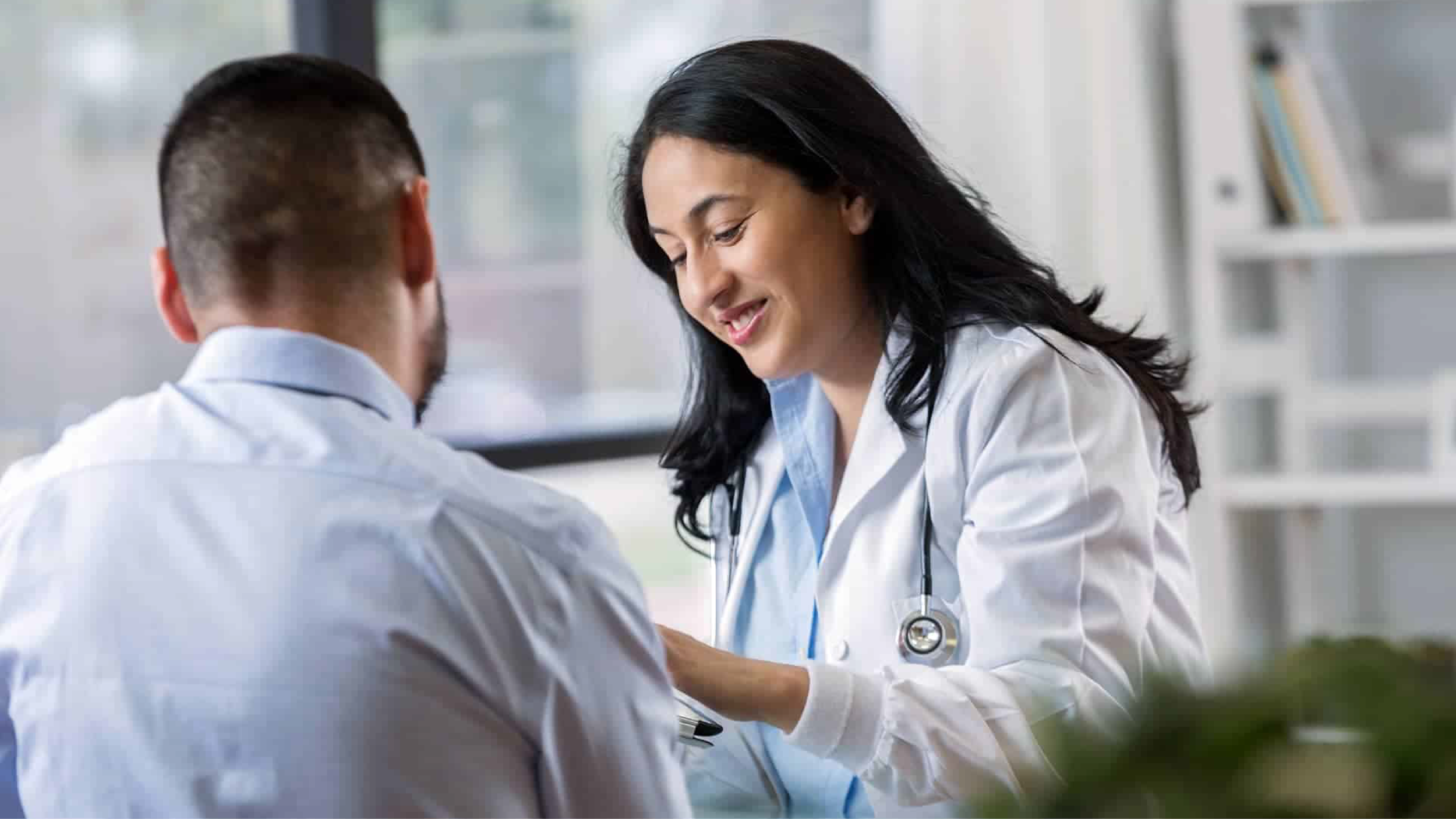 Prevention Thumbnail A health care provider talking to a patient. Both are looking at something the provider is holding.