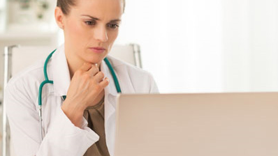 Provider at computer Doctor reading from a laptop