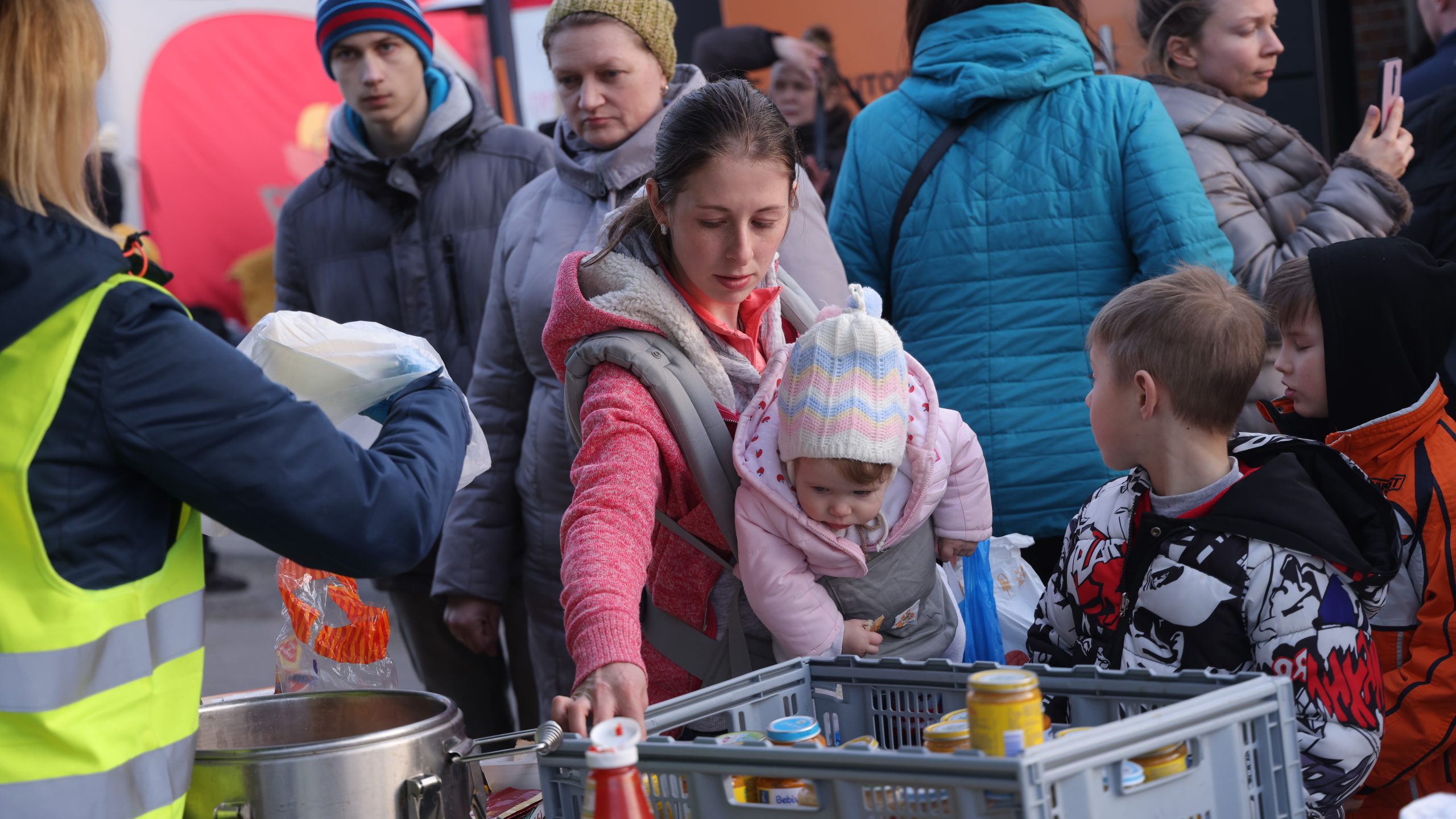 — title missing — Mother and child collecting food at a shelter.