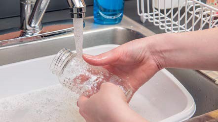clean-feeding-items-4 A person rinsing a bottle with safe water.