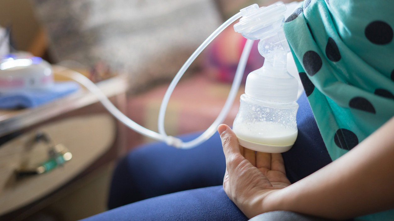 Pumping breast milk at work A mother using her breast pump at her office desk