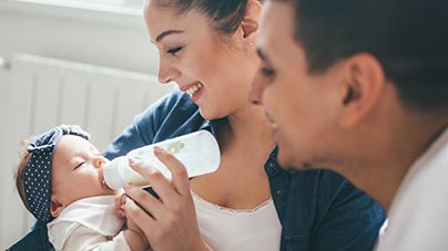 Bottle feeding Parents feeding infant with a bottle.