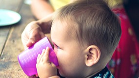 toddler-cup An older infant drinking from a cup.