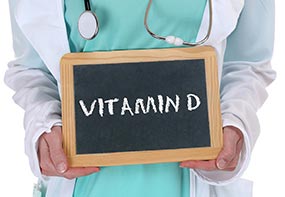 howmuchformulafeed.jpg A physician holding a sign saying vitamin D.