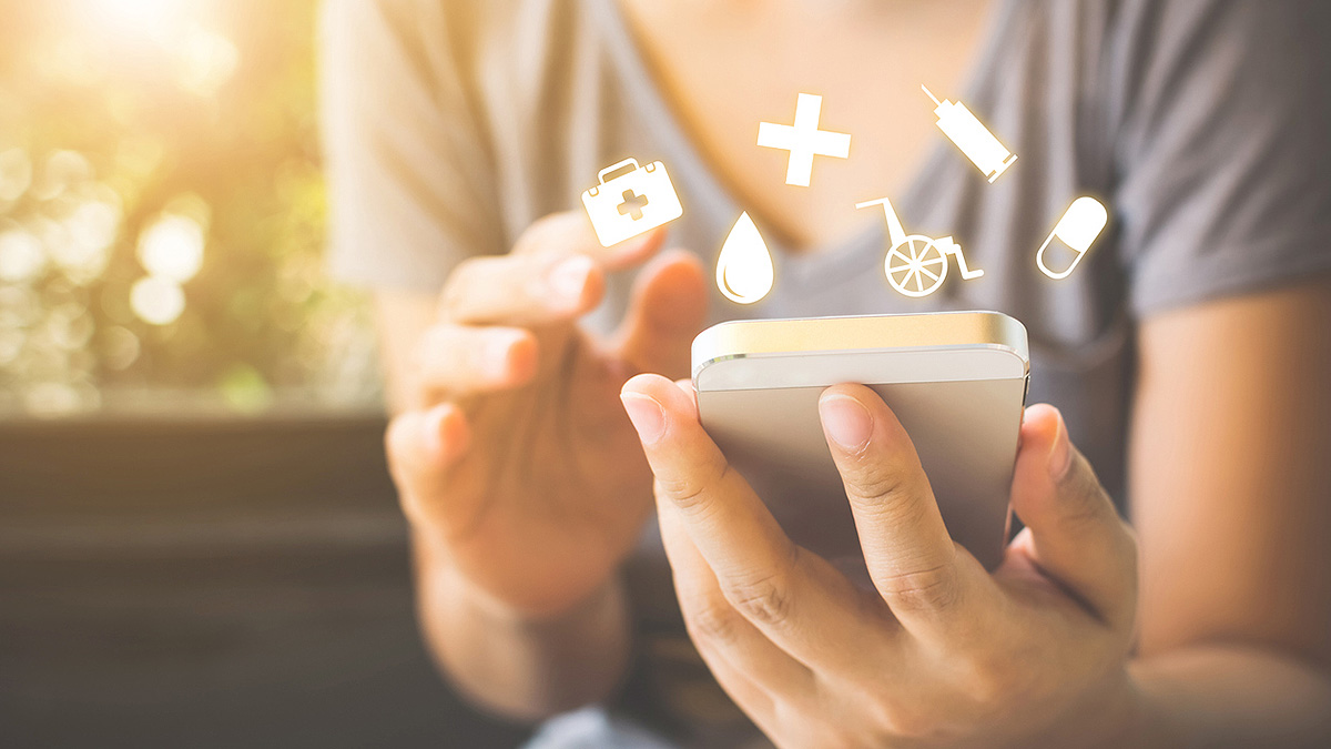 IBD Phone and Medical Icons Woman using smartphone as medical icons such as the medical cross, a needle, and pill icon hover above.