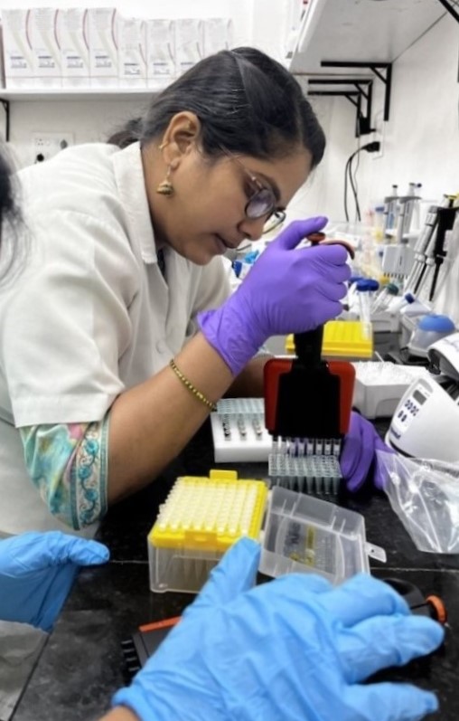 GAIHN Work in India using Whole Genome Sequencing to Combat AR A person in lab coat and gloves uses an instrument for whole genome sequencing in a laboratory.