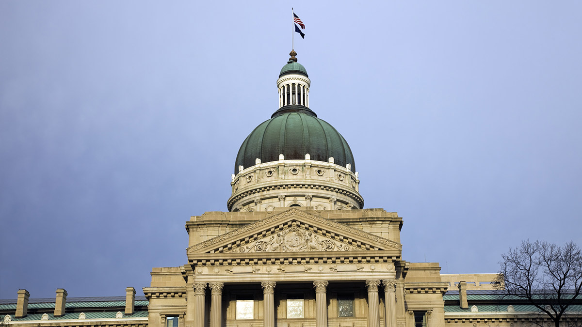 Marion County The Indiana state capitol building, featuring a large green dome and ornate stone facade under a cloudy sky.
