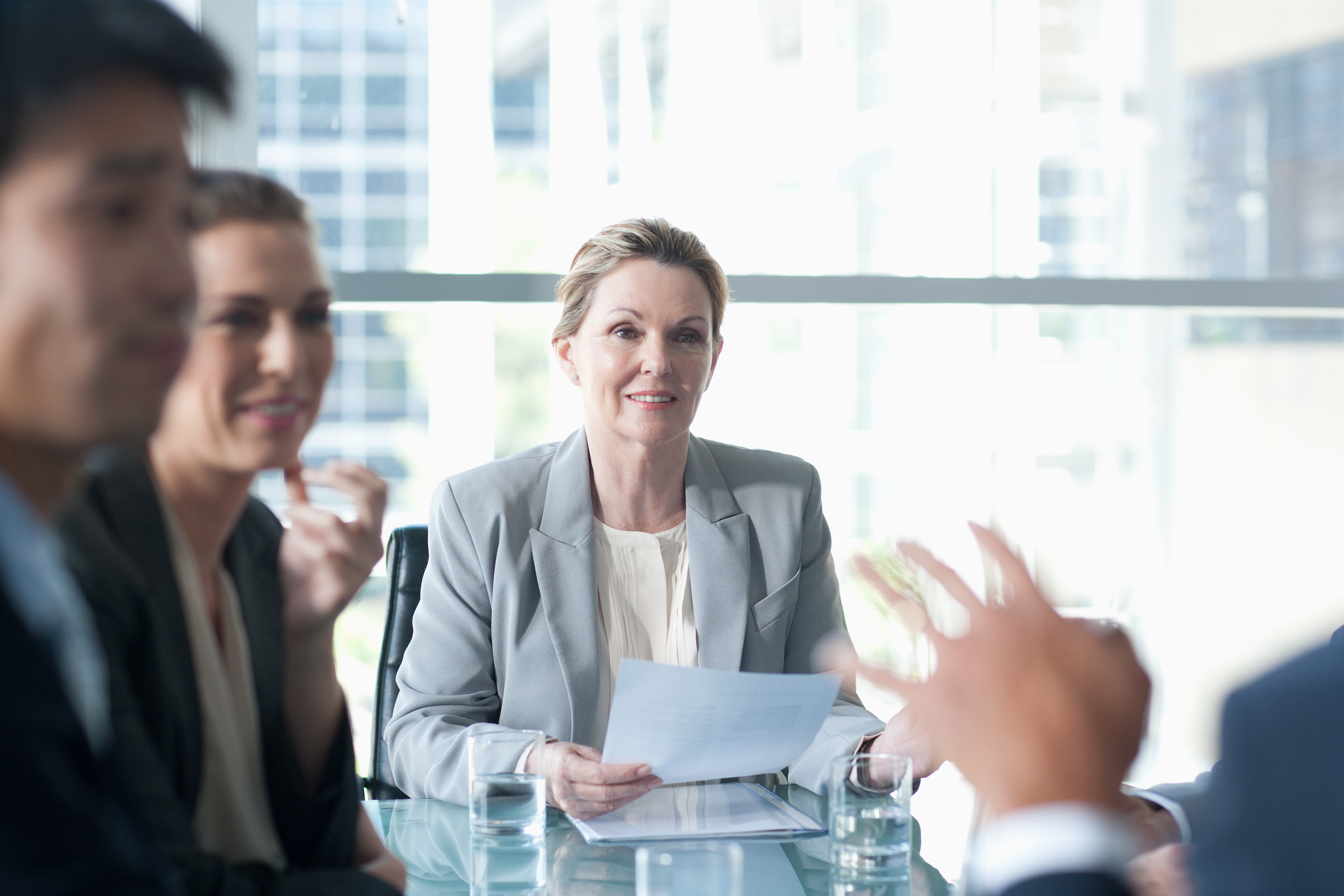 Smiling businesswoman leading meeting in conference room Woman leading a meeting.