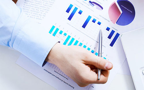data_statics.jpg Image of a person's hand and partial arm pointing to bar and pie charts.