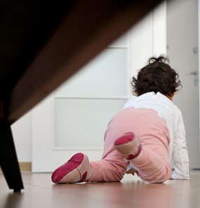 Baby girl crawling Baby girl crawling towards an open door.
