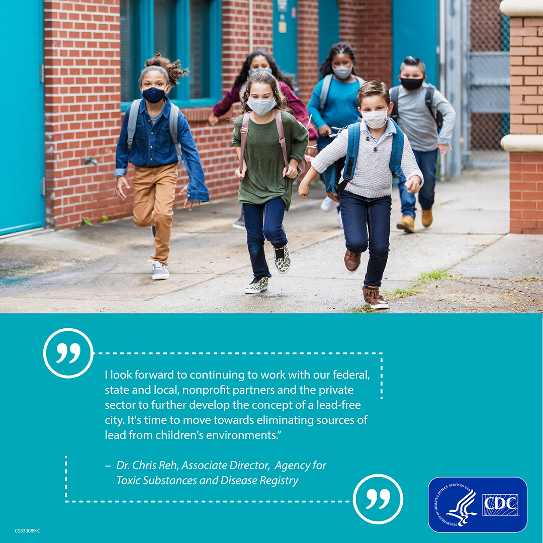 Kids at school School children wearing mask and backpacks run down a path between two brick buildings with a quote on a blue banner below.