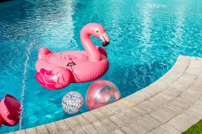 Pool float A flamingo pool float in a pool with floatable balls