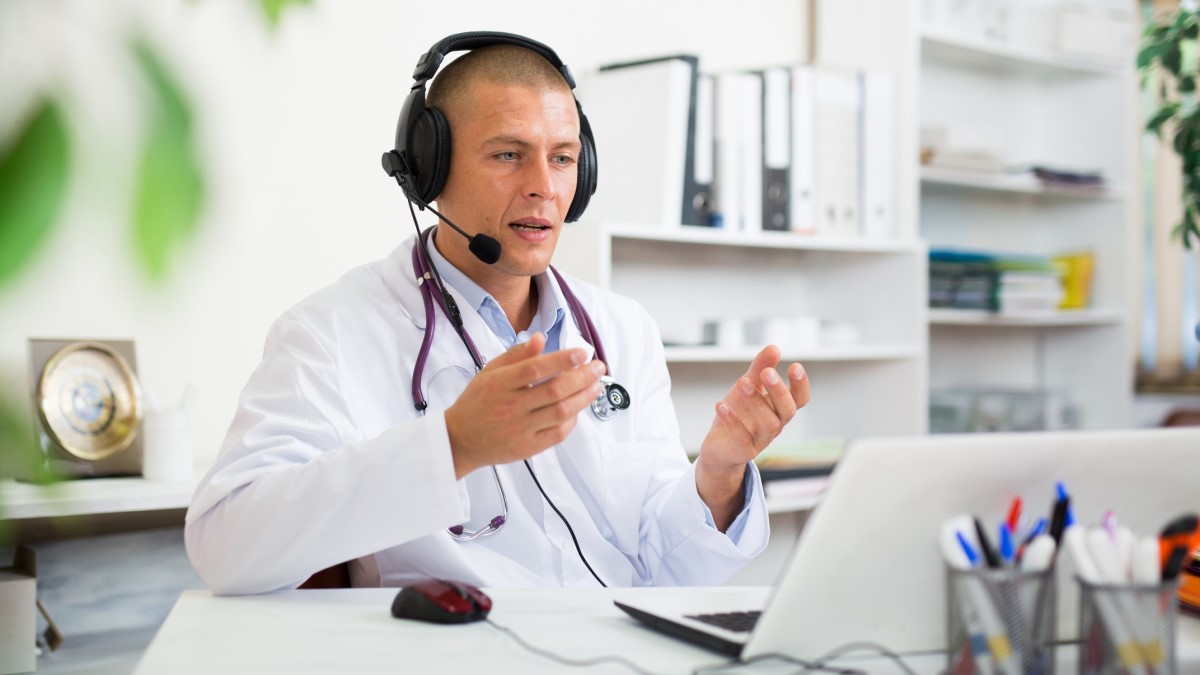 Doctor Call A doctor or pharmacist with his laptop having a phone discussion