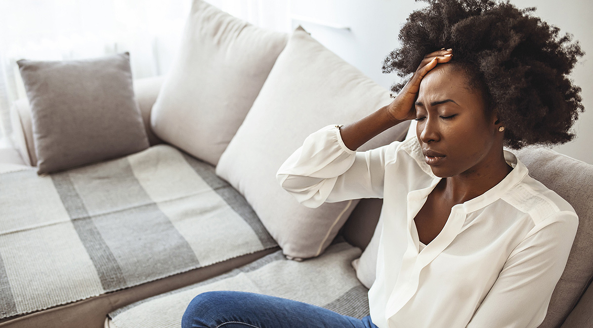 -- title missing -- A very tired woman sitting on a couch