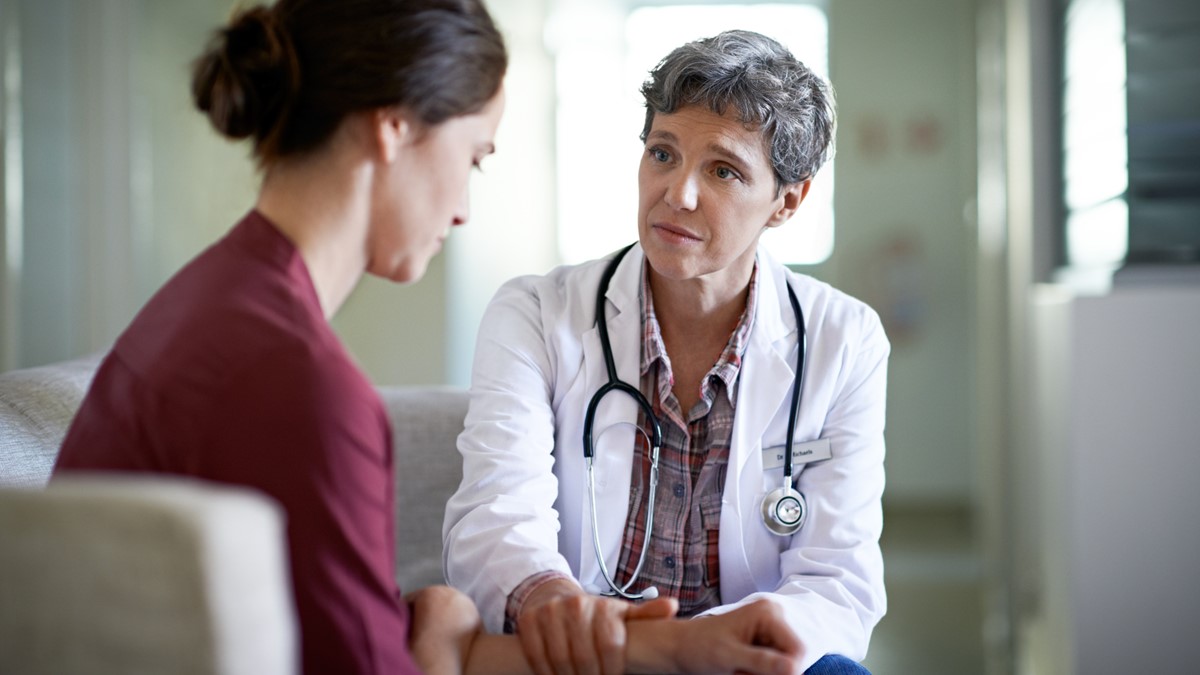 Woman and Doctor A doctor talking to a patient