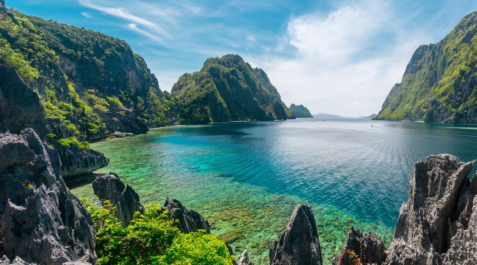 El Nido, Philippines Beautiful, sun-lit view of El Nido, Philippines. Ocean bay surrounded by tall vegetation-covered rock formations