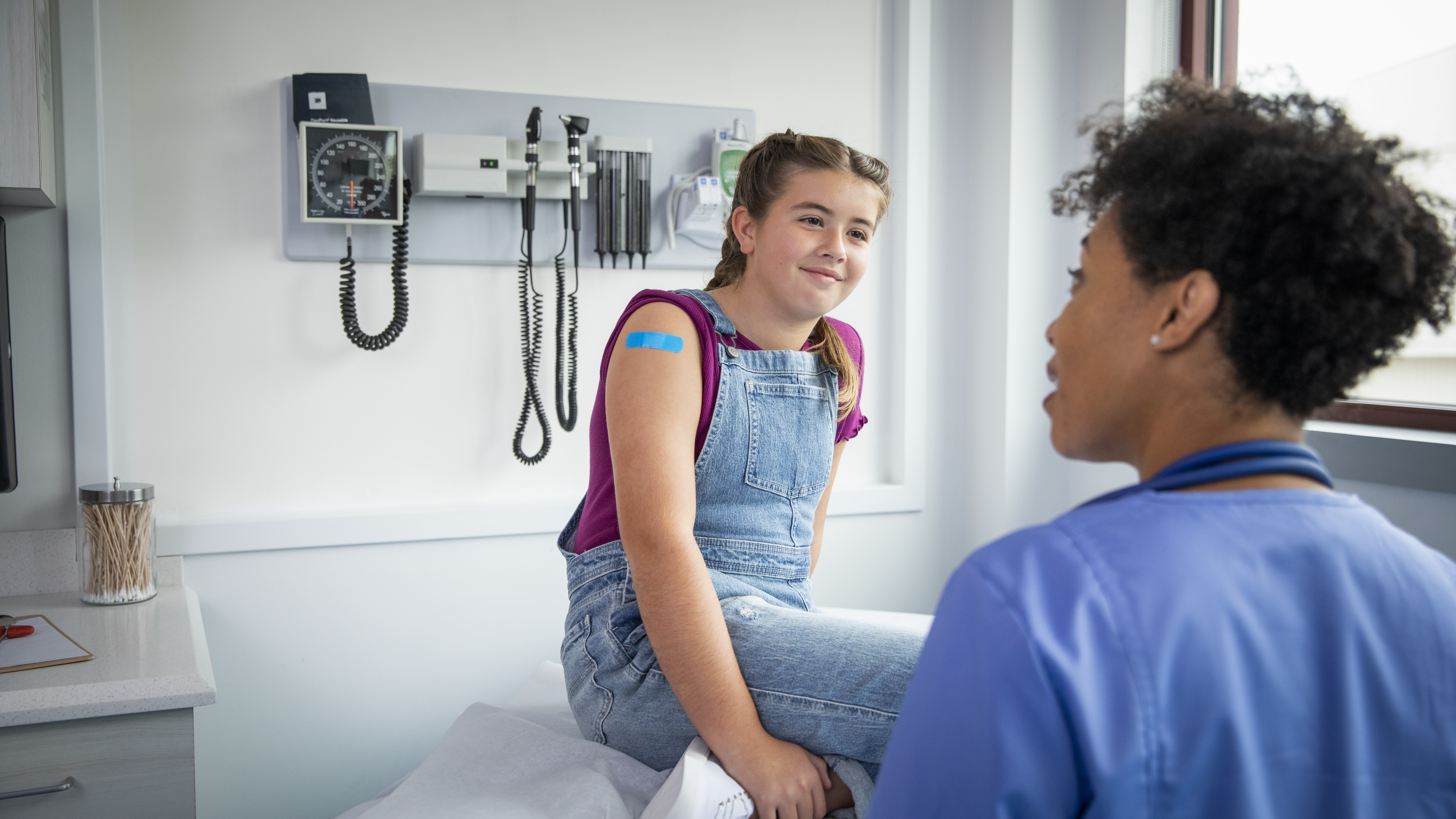 patient talks with HCP A pediatric patient talks with healthcare provider after receiving vaccination.