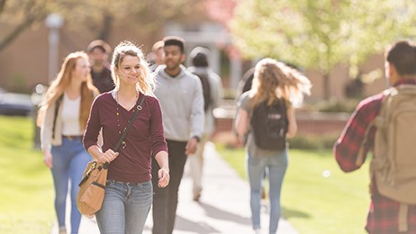 College student walking College students walking on the sidewalk to class.