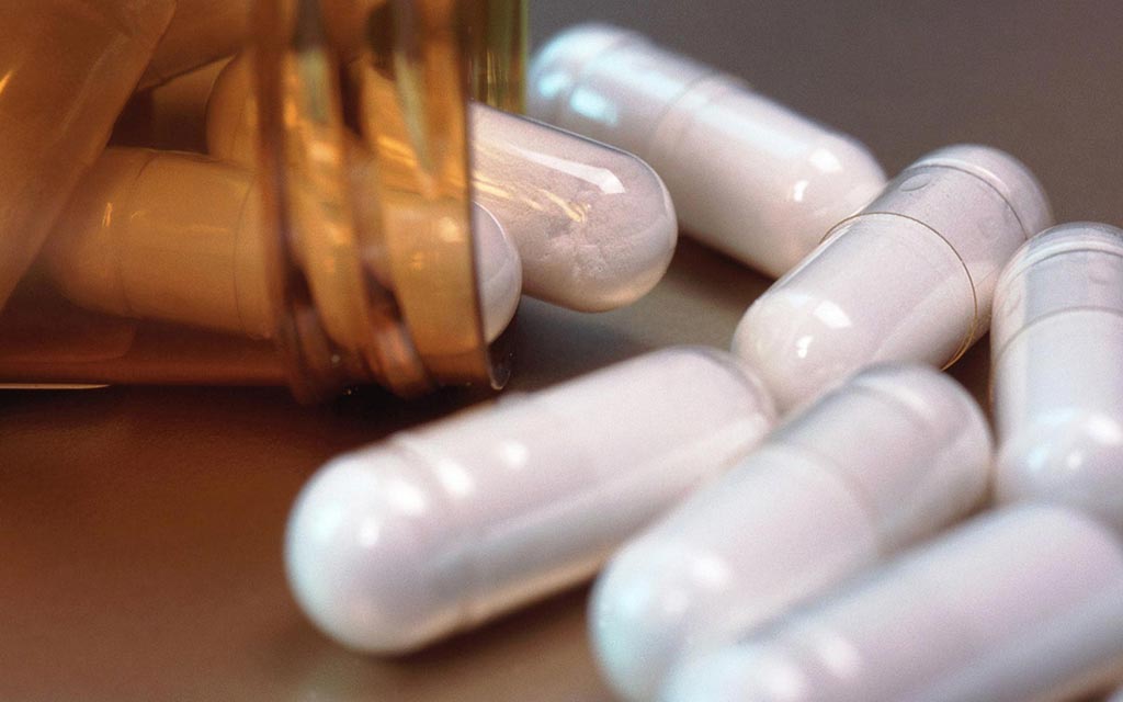 Medication, capsules spilled from a medicine container.
