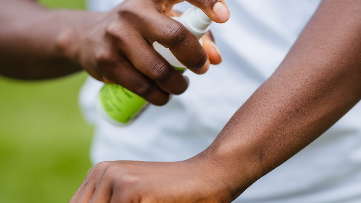 Apply insect repellent Person applying insect repellent to their arm