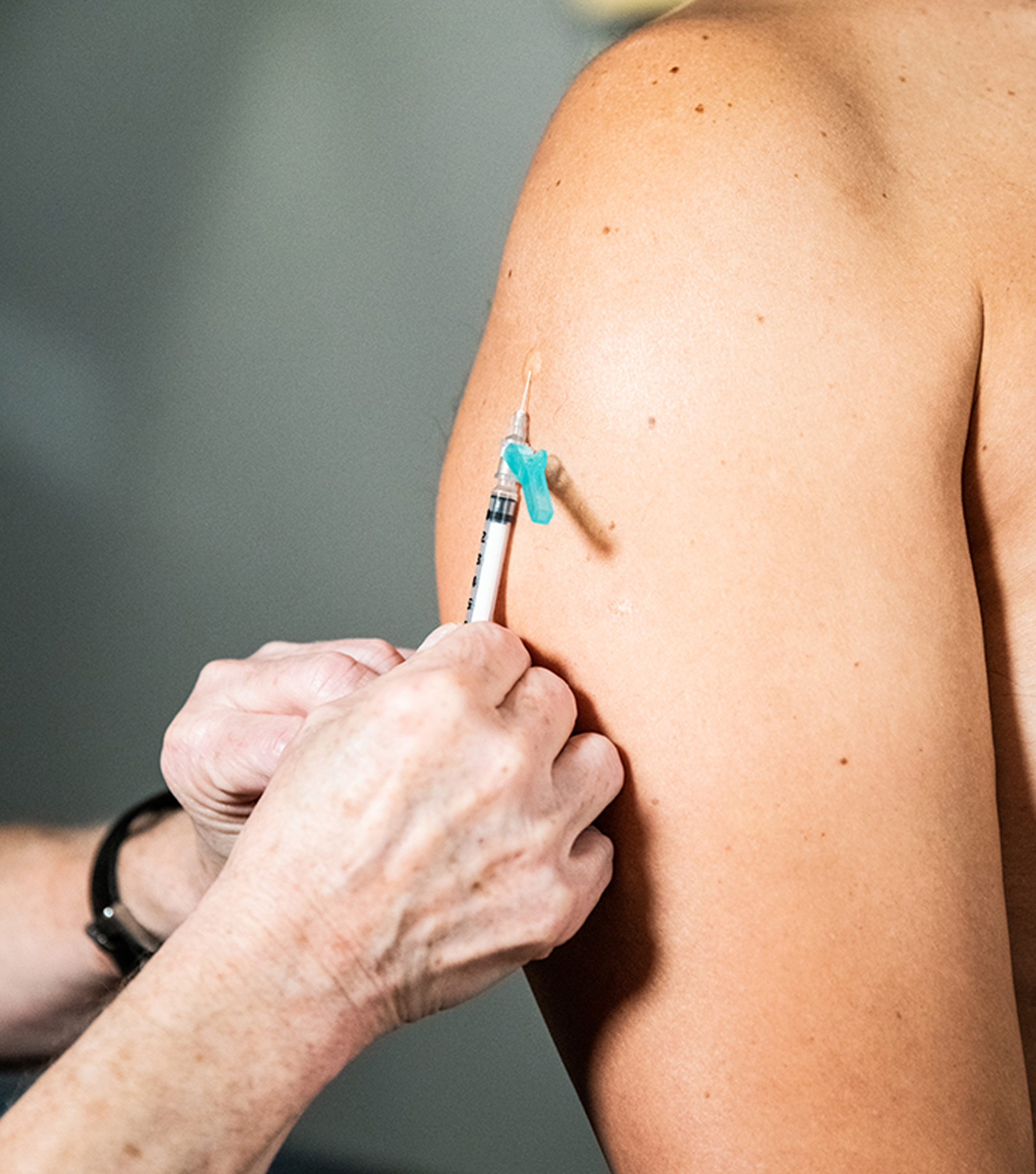 Mpox Injection Site 4 Image of a hand inserting a vaccination into a light-skinned person's deltoid.