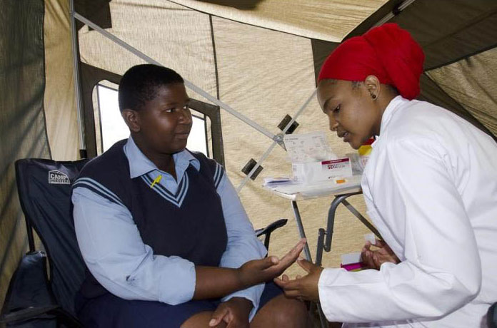 areas-study-public-health2 Two adults interacting in a medical tent