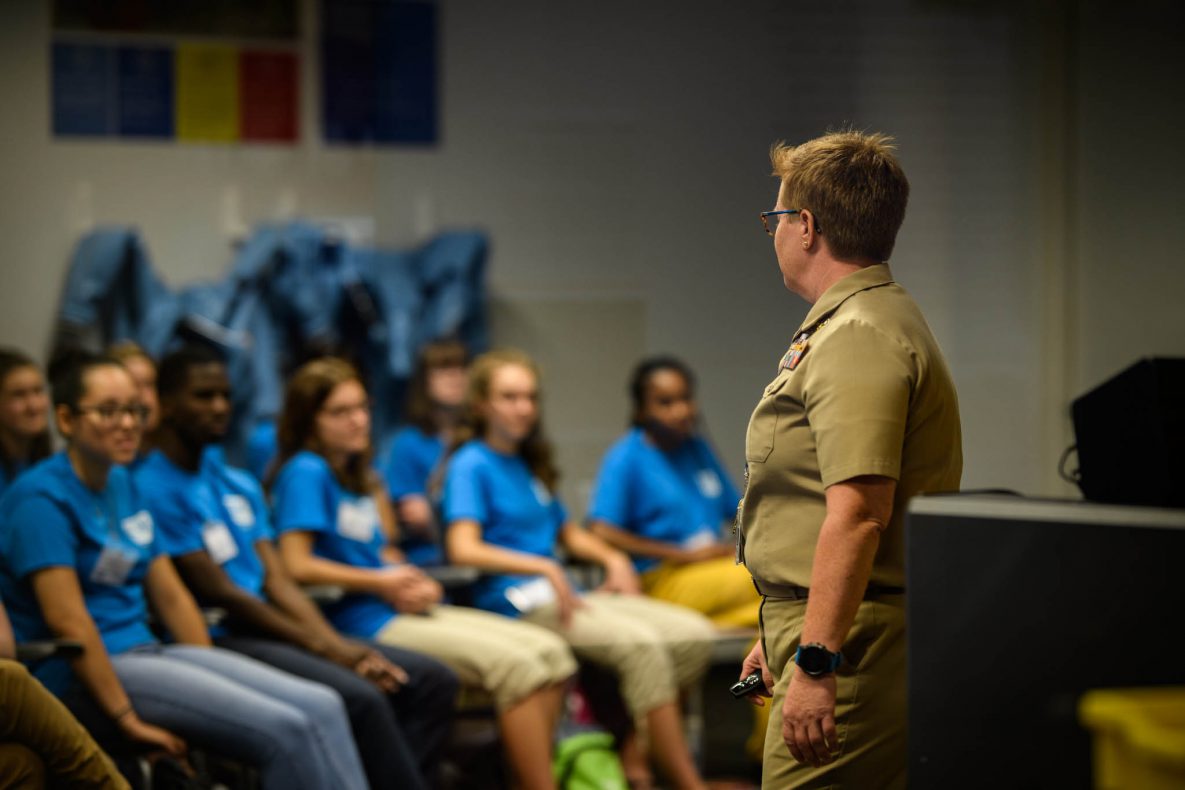 adult-speaking-seated-students Adult speaking to seated students