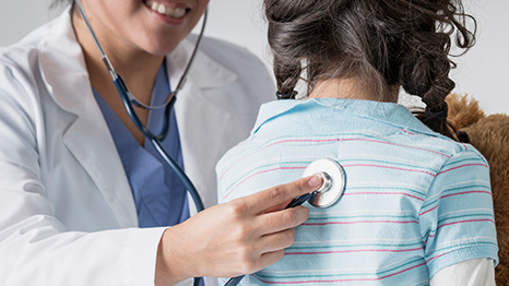 — title missing — A healthcare provider listens to the lungs of a young girl.