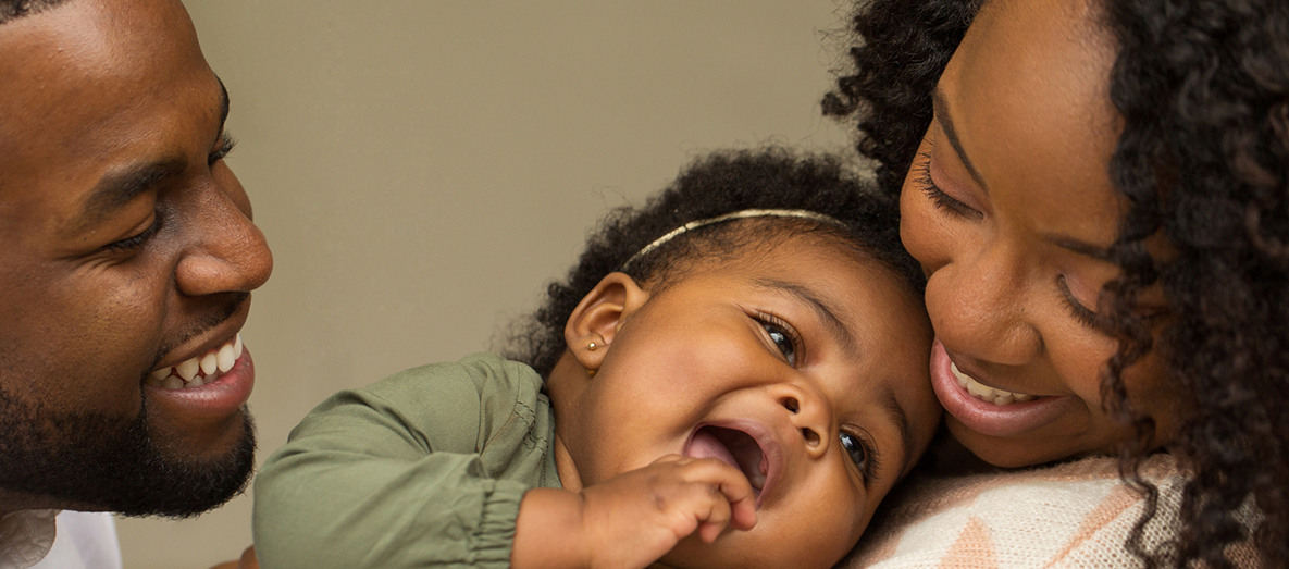 Happy African American family with their little girl.