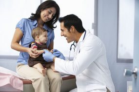 Doctor In Surgery Examining Baby Girl Doctor In Surgery Examining Baby Girl