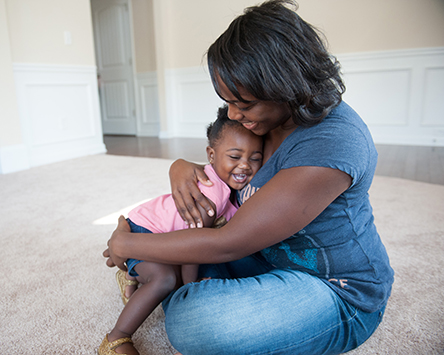 18 Months_Shows affection to familiar people-444px Mother holding her daughter while sitting on the floor
