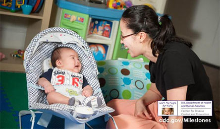 Mom playing with baby smiling