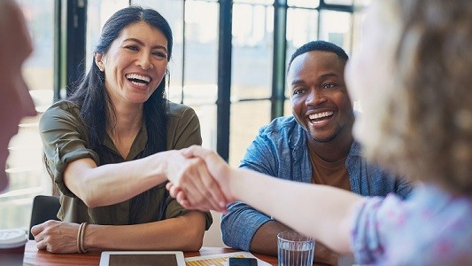 funding-banner Professionals at a table shaking hands