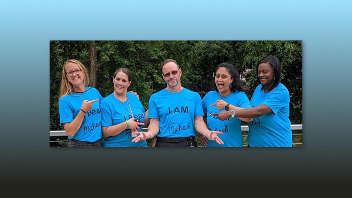 I Am Michael A group of women each with a shirt that reads I Beat Michael surrounding a man wearing a shirt that reads I Am Michael.