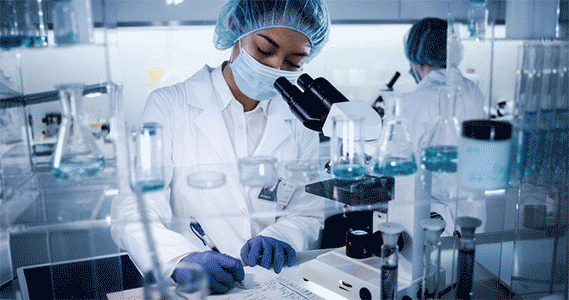 labphotocareerswebpage569x300.png Female writing on paper in front of a microscope