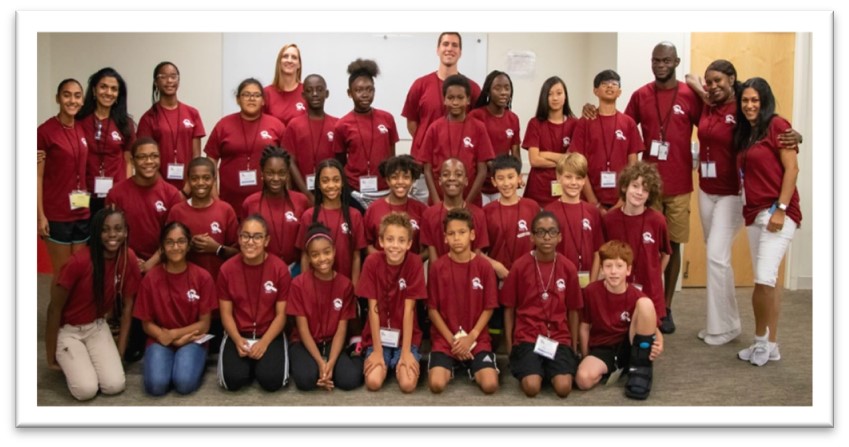 prev4 2019 camp group photo showing 30+ campers and staff in matching red shirts.