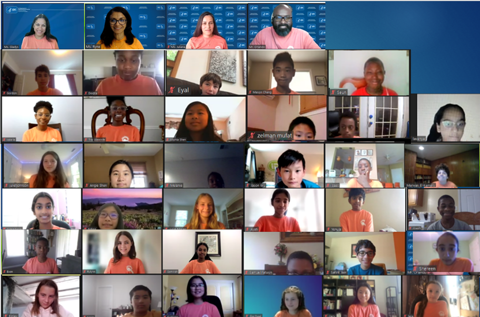 prev7 2022 virtual camp group photo. A screenshot showing Zoom windows of campers and staff wearing matching orange shirts.