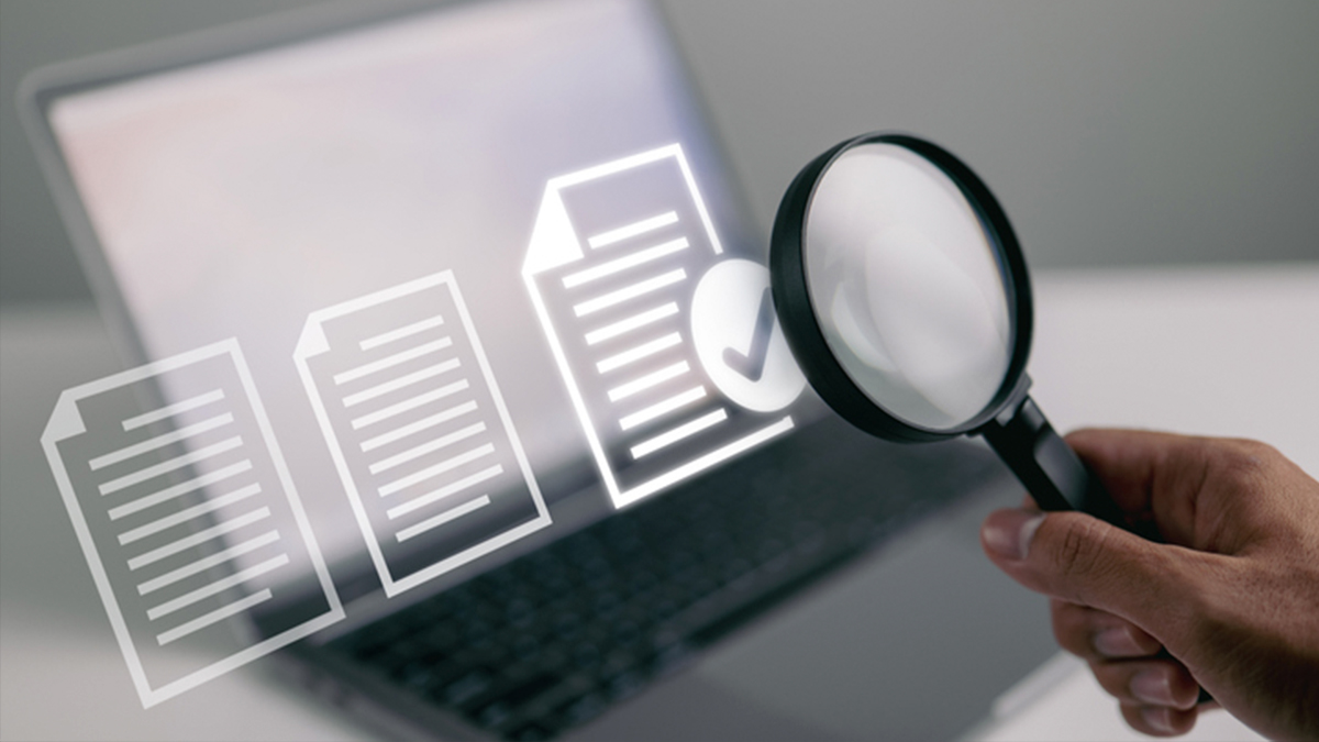 RANDS Thumbnail v2 Conceptual image of hand with magnifying glass reviewing documents