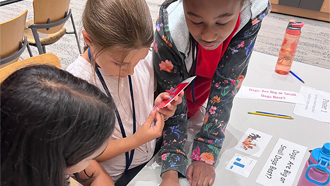2024 Data Detectives Atlanta - 2 Students organizing a visual presentation.