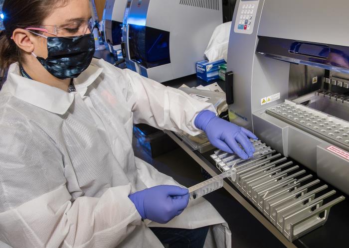 scientist-preparing-samples-analysis Female scientist preparing samples for Real-Time Reverse Transcriptase (RT)–PCR analysis of SARS-CoV-2 specimens