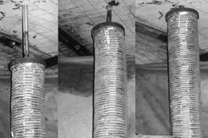 Three black and white pictures of a section of mine ceiling. The ceiling is buttressed by wire mesh and steel angle iron and the pictures are taken from the same position over time. In the foreground of all three pictures is a roof bolting drill bit, surrounded by a collapsible drill steel enclosure(CDSE), as it drills into the mine ceiling. In each picture the CDSE moves closer to the mine ceiling.