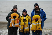 paul_revere_crew The three crew members of the setnet skiff Paul Revere posing on the shore of Bristol Bay, Alaska with the inflatable personal flotation devices that saved their lives.