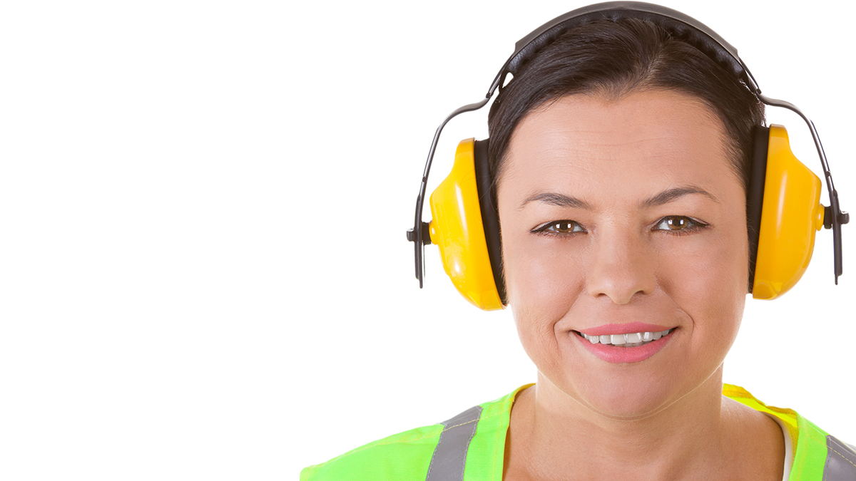 840908174 Female worker wearing hearing protection.