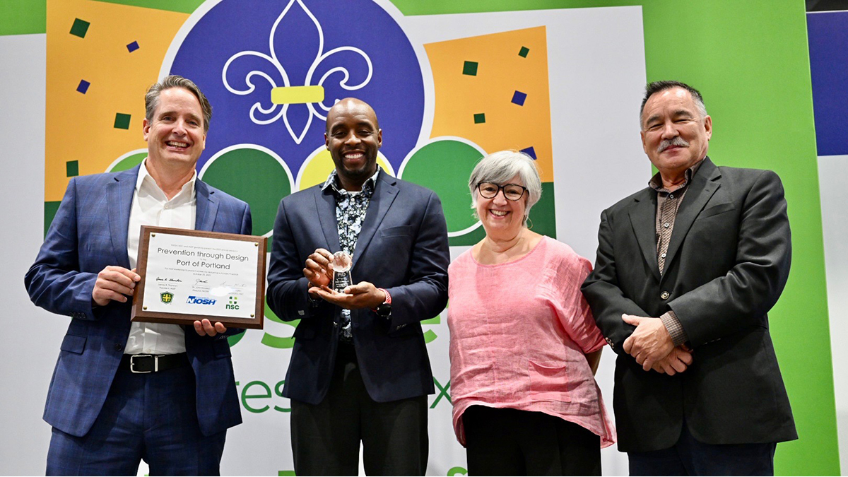 2023 PtD Awardee: Port Authority of Portland Three men and one woman from the Port of Portland are holding the 2023 PtD Award they received at the National Safety Congress and Expo