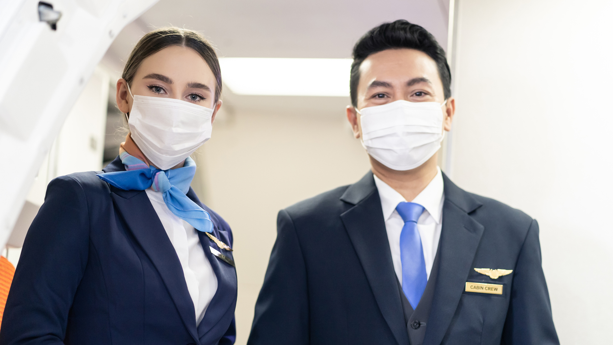 1312141650 Aircrew members wearing face masks to minimize direct exposure to sick travelers with respiratory symptoms.