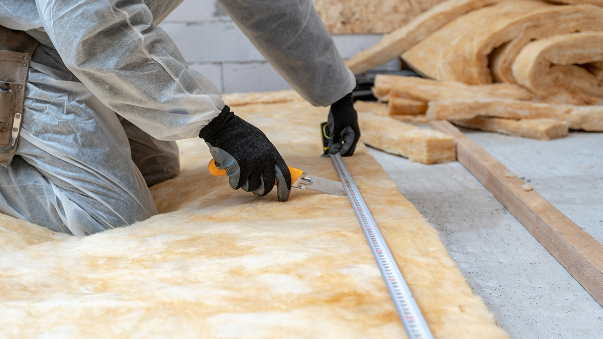 Professional workman installing thermal insulation rock wool Professional workman installing thermal insulation rock wool